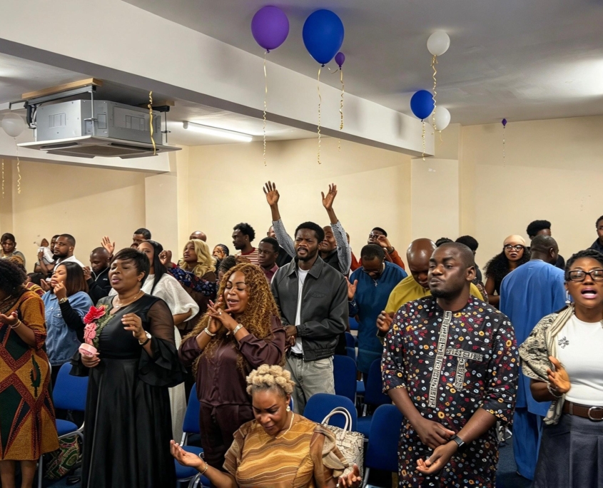 Congregation worshipping together with raised hands