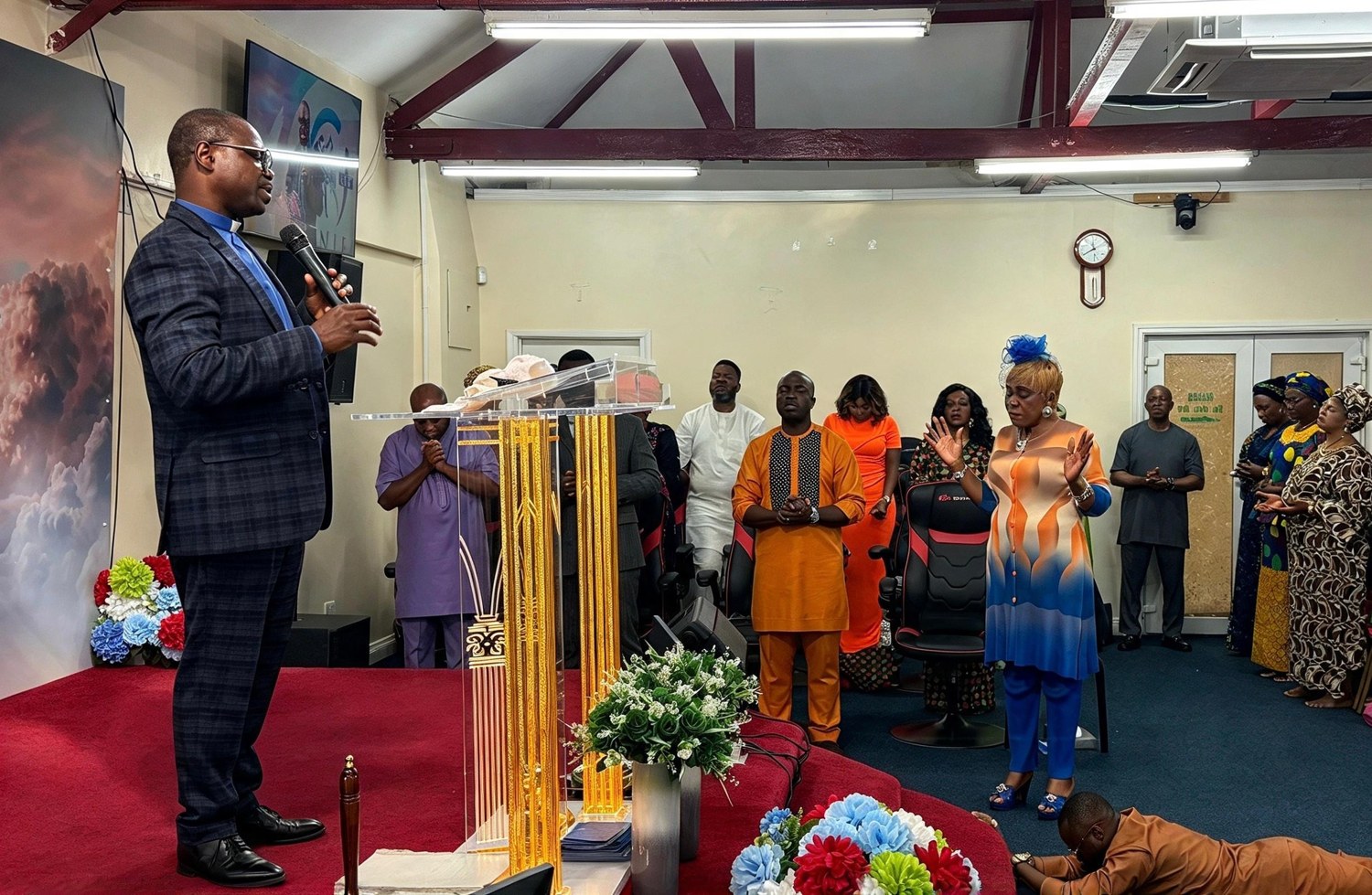 Pastor Sunday leading the congregation