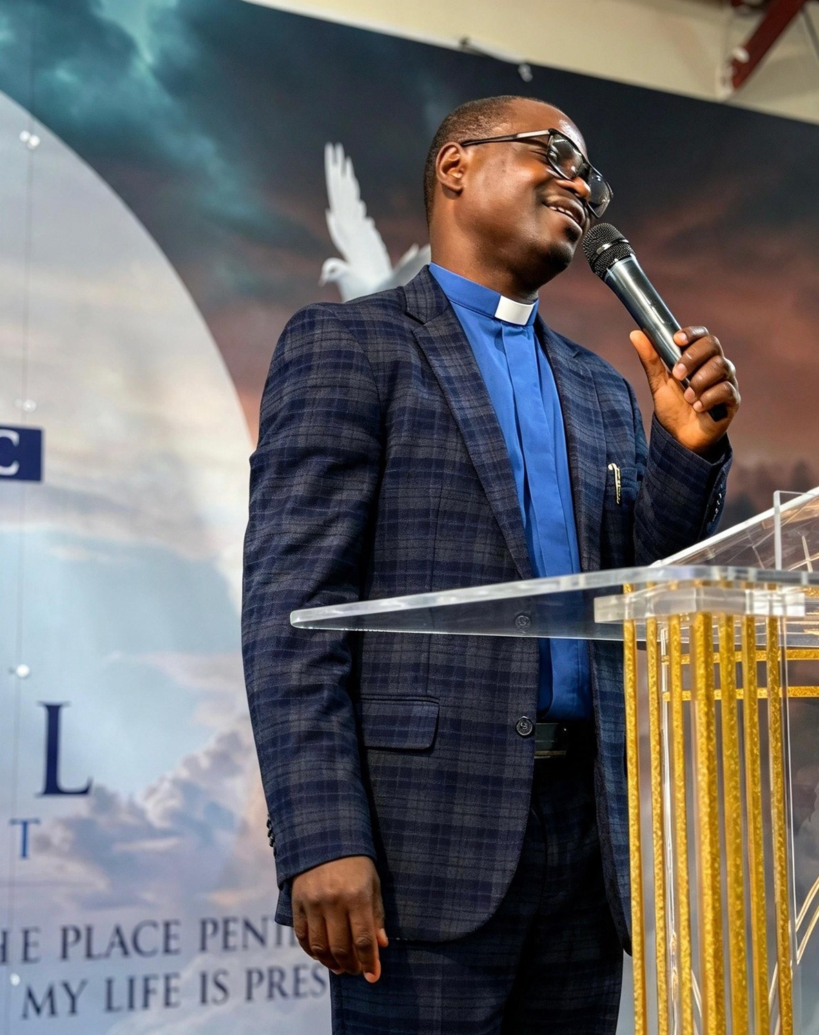 Pastor Sunday Olaniyan preaching from the pulpit